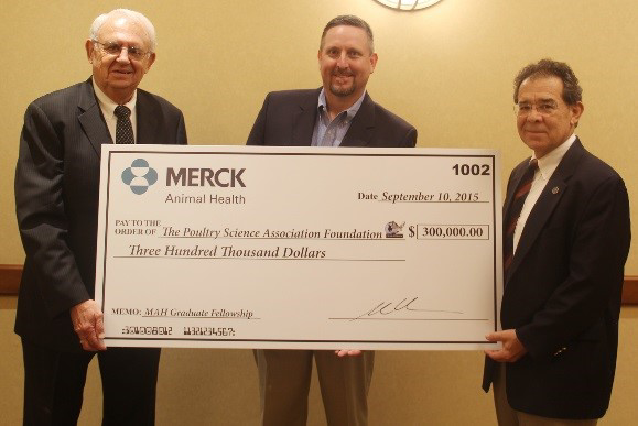Travis Boatwright of Merck Animal Health presents the check to E. Ernest M. Pierson, Ph.D., Chair of the Poultry Science Association Foundation Board of Trustees.  Also pictured is James H. Denton, Ph.D., Chair of the PSA Foundation Capital Campaign.